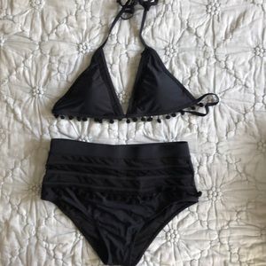 High-waisted black bikini with tassels